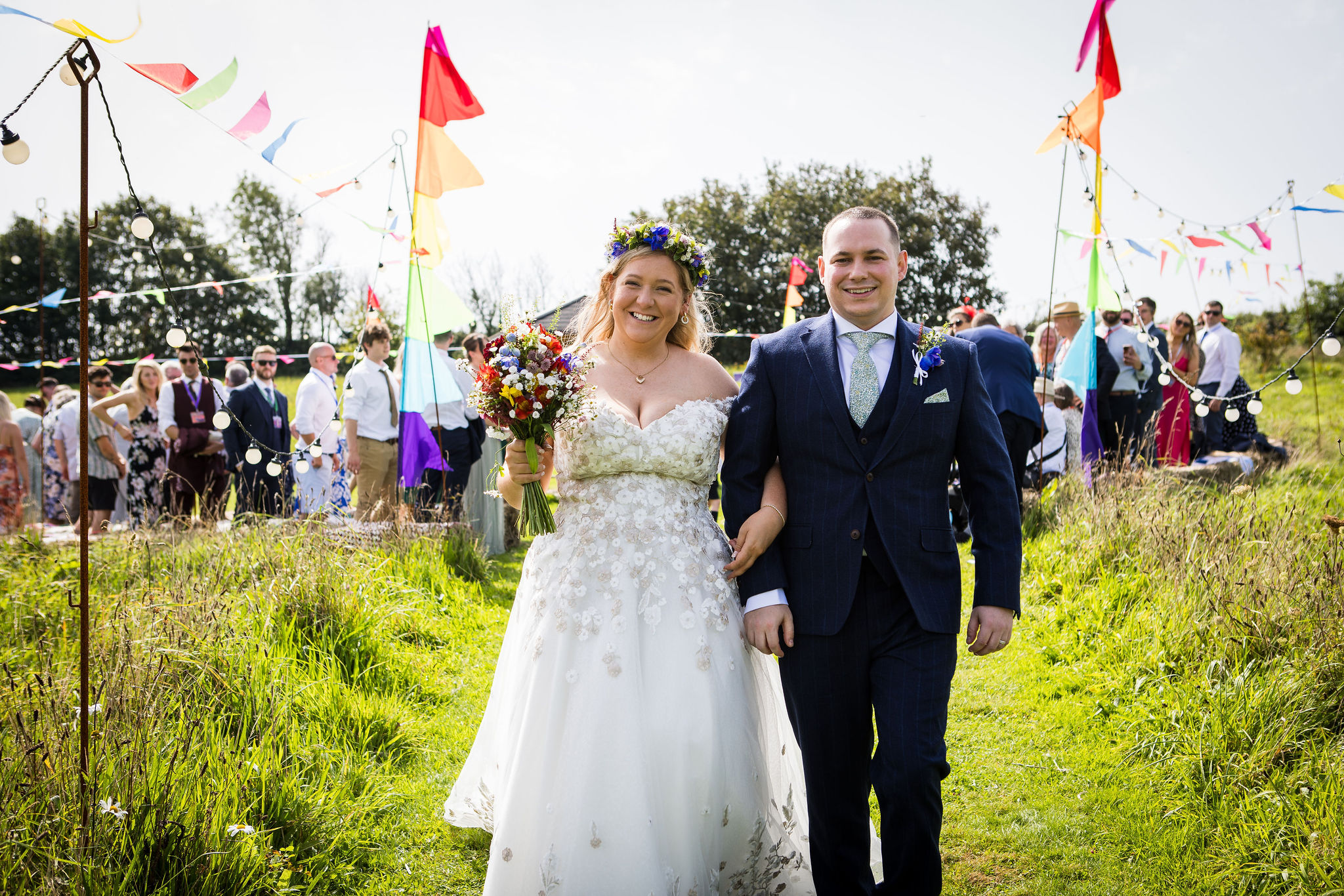 bride and groom just married and walking back down the aisle at their festival wedding