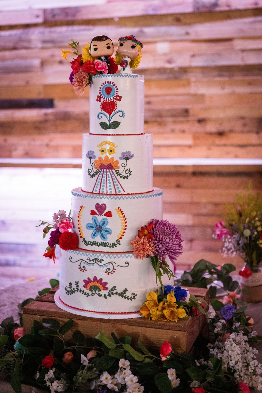 colourful four tier wedding cake with folk art design