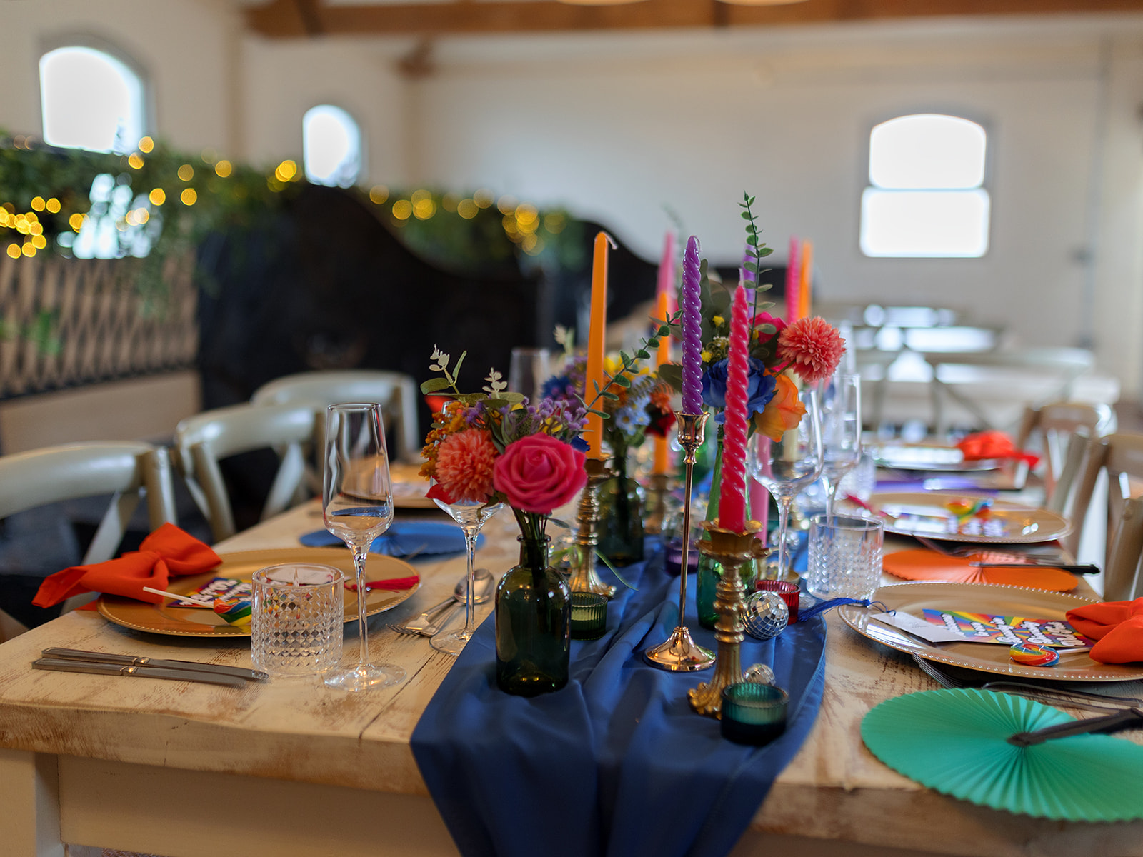 colourful candles and flowers for rainbow wedding
