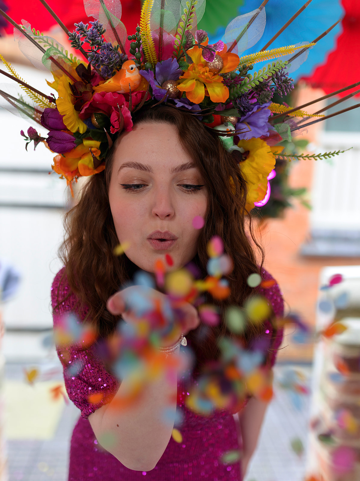 fun wedding photo of bride blowing confetti into the camera