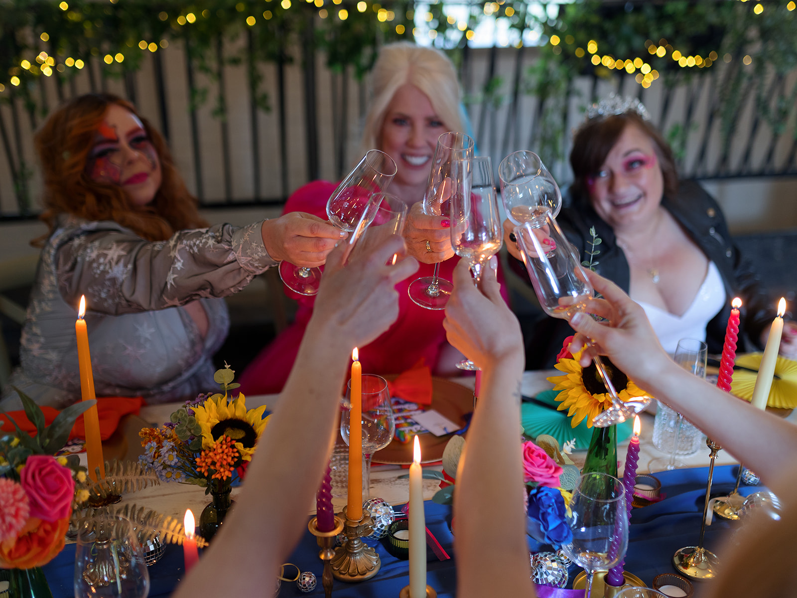 colourful wedding table styling with rainbow candles