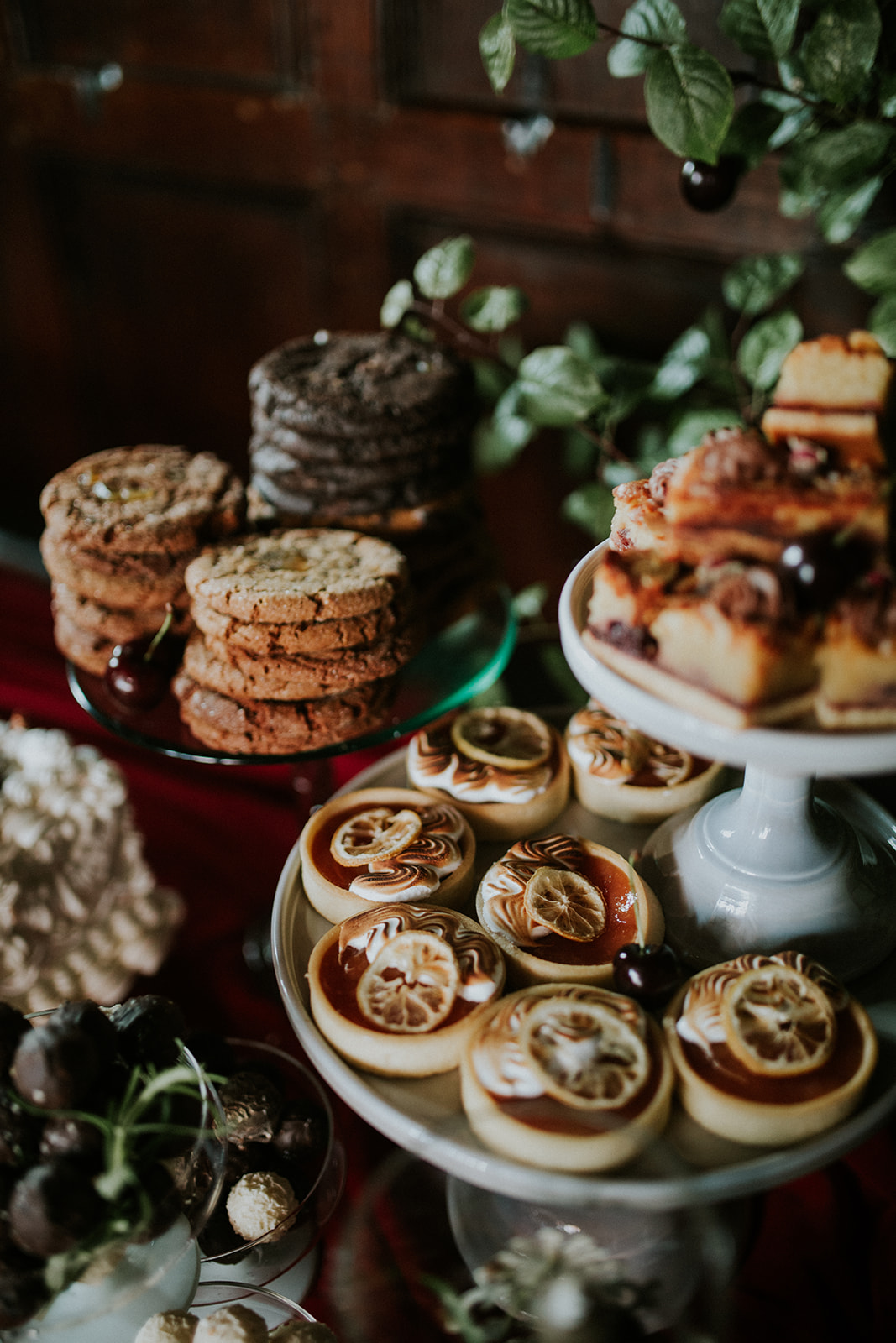 detail shot of a alternative wedding breakfast desert table with cake plates and tarts