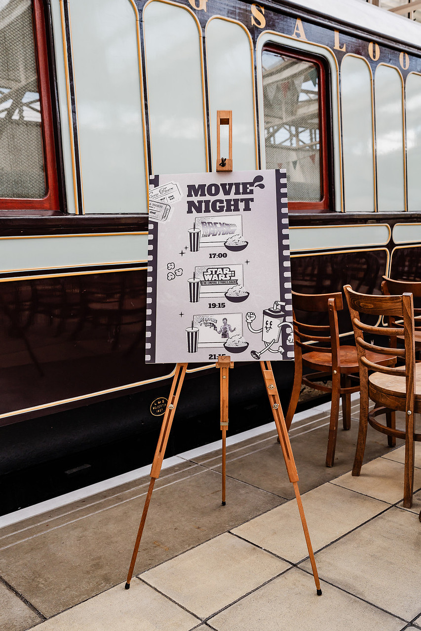 movie night board showcasing films available to watch in the vintage train carriage