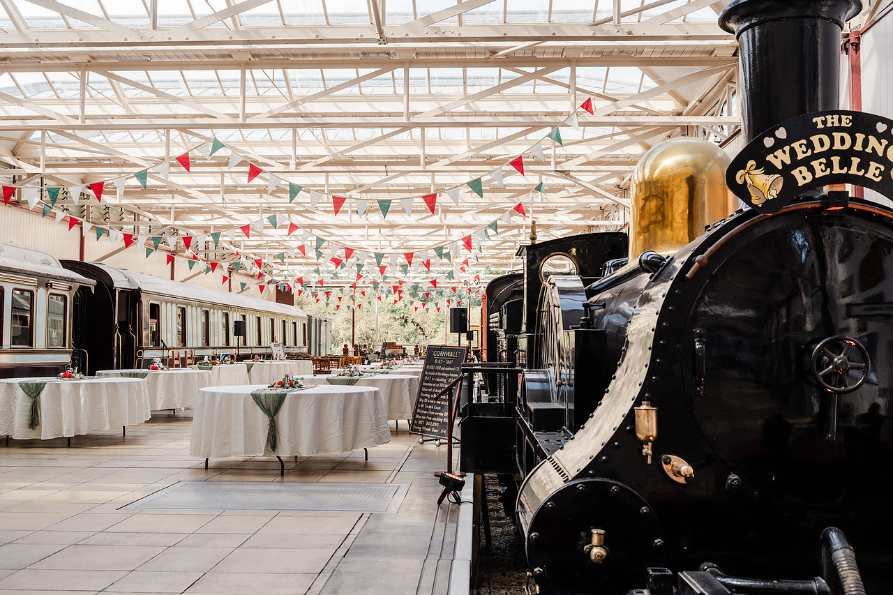 detail shot of vintage steam train and carriages inside a railway wedding venue.