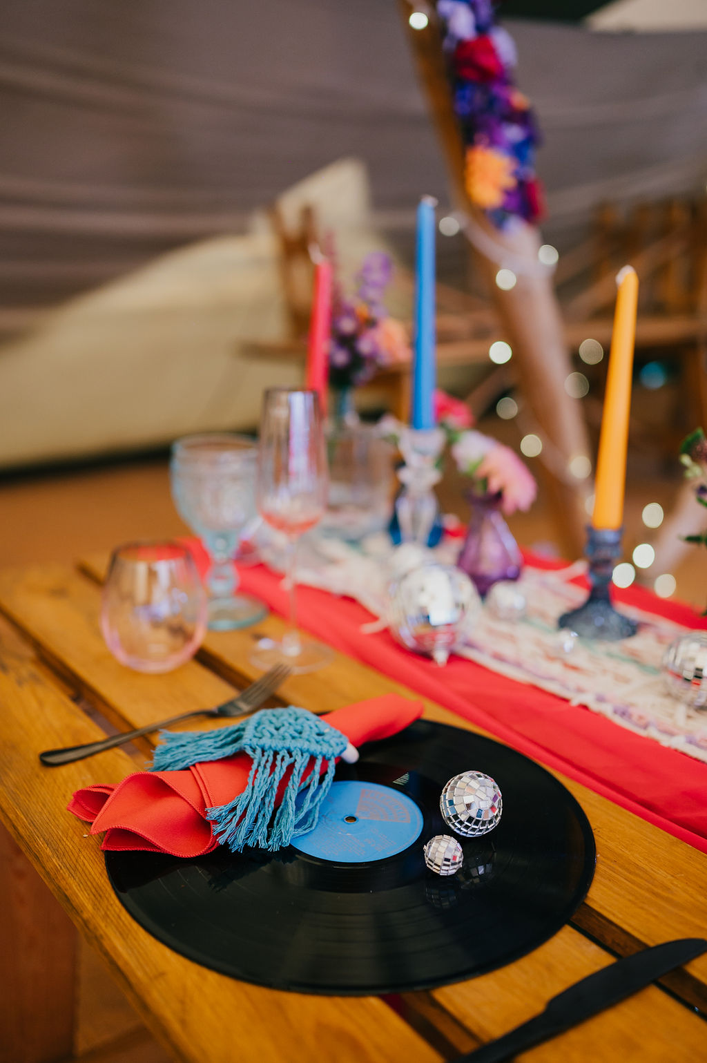 vinyl record place setting with macrame and disco balls for festival styled wedding