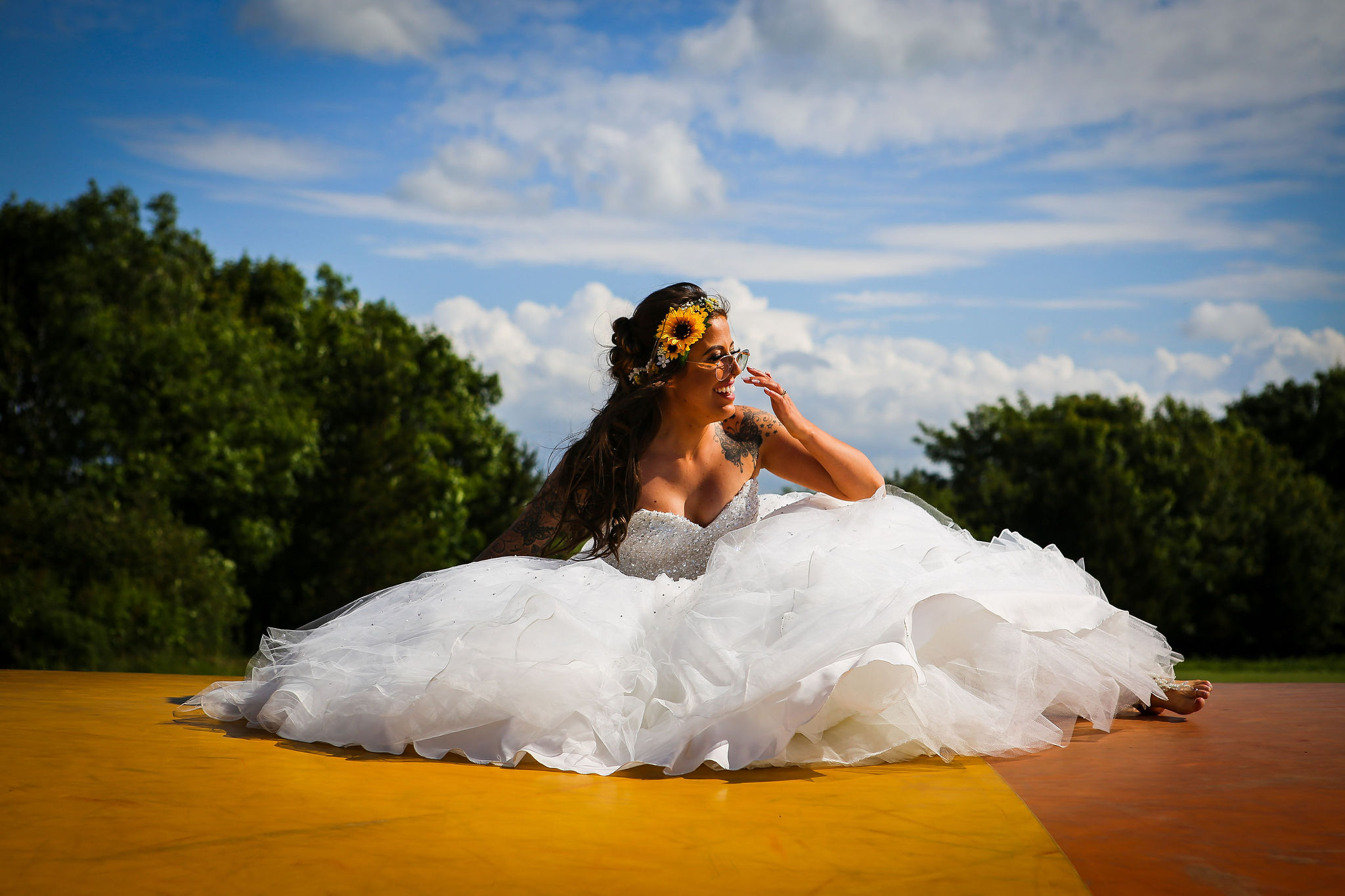 Harriet&Rhys Wedding - Magical sunflower wedding - unique wedding full of surprises - bride on bouncy castle
