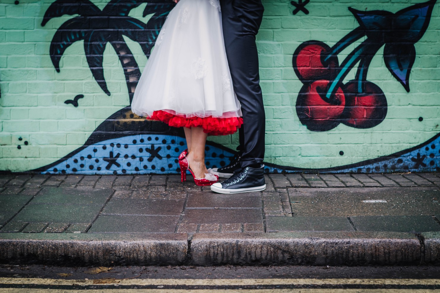 red high heels - retro wedding shoes - converse wedding shoes against an urban wedding backdrop