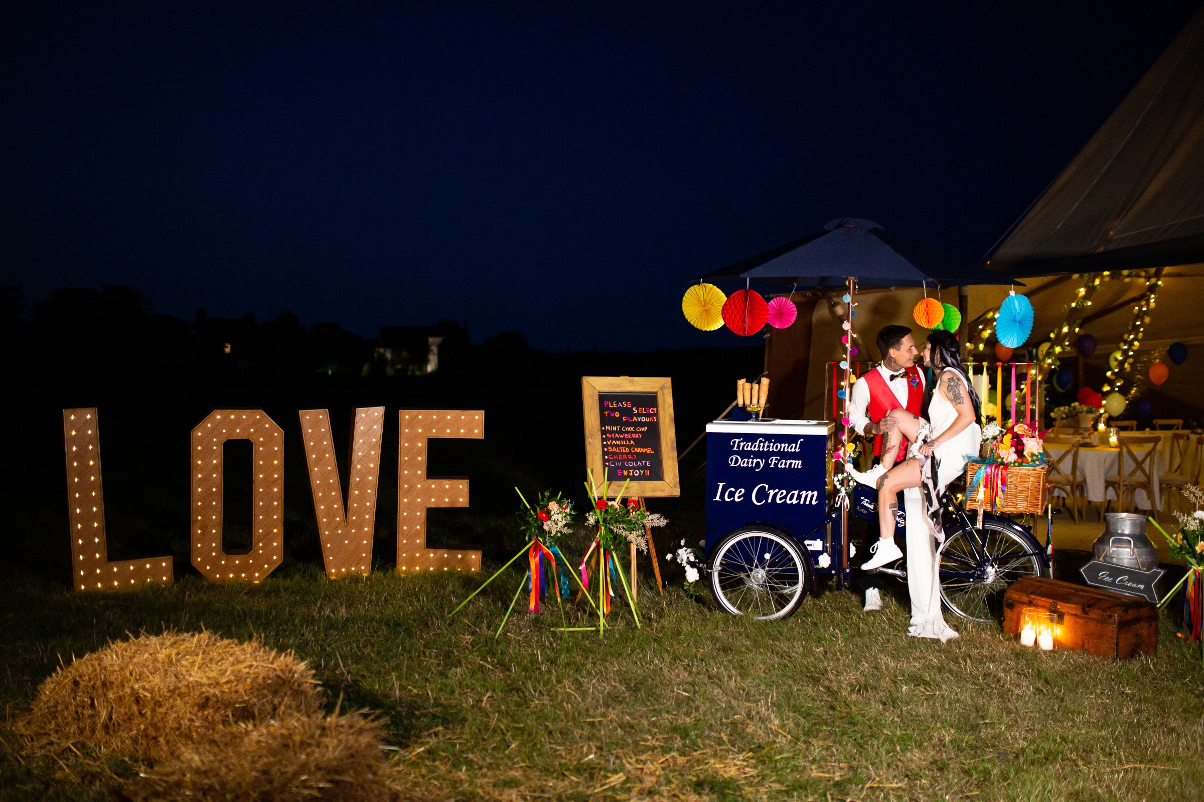 rainbow festival wedding - colourful wedding - quirky wedding ideas - love light up sign - wedding ice cream cart