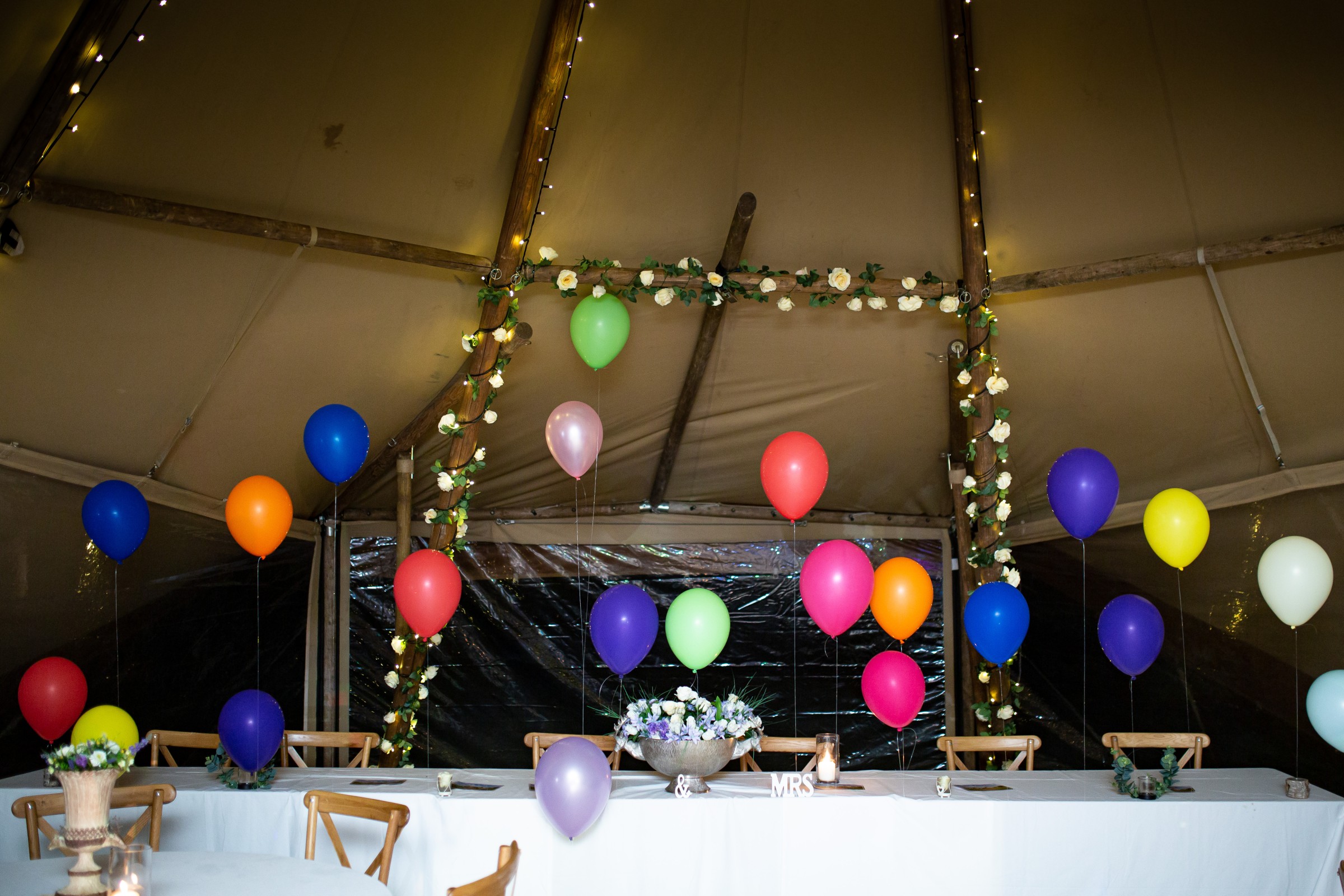 colourful balloons in a marquee for a rainbow festival wedding