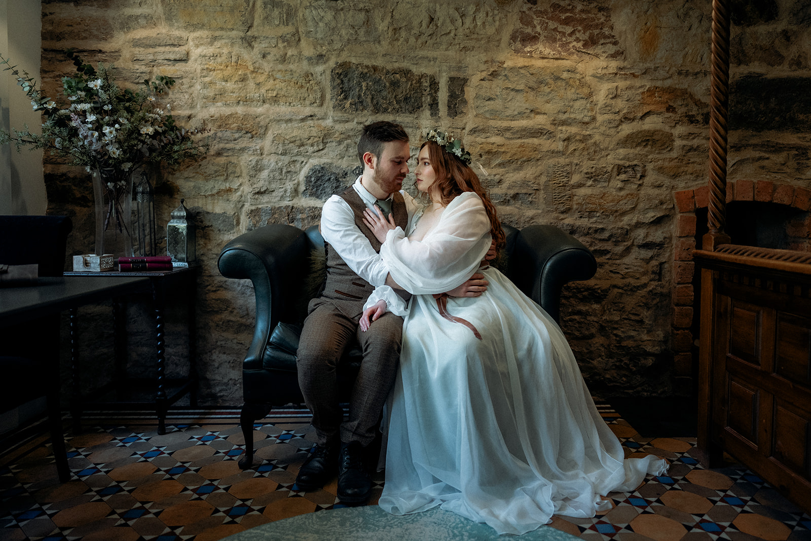 Ethereal wedding dress designed by Cora Stitch in Scotland. Bride and groom sat having a private moment together.