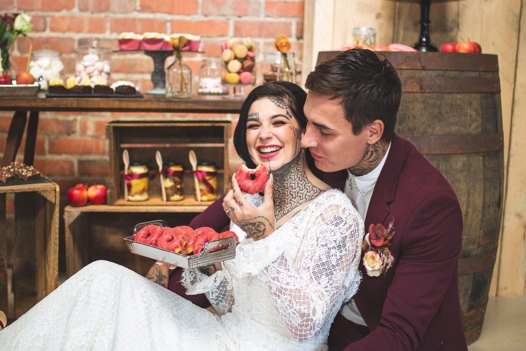 unique barn wedding - wedding grazing table - unique wedding food - wedding buffet - wedding dessert table - bride eating doughnuts