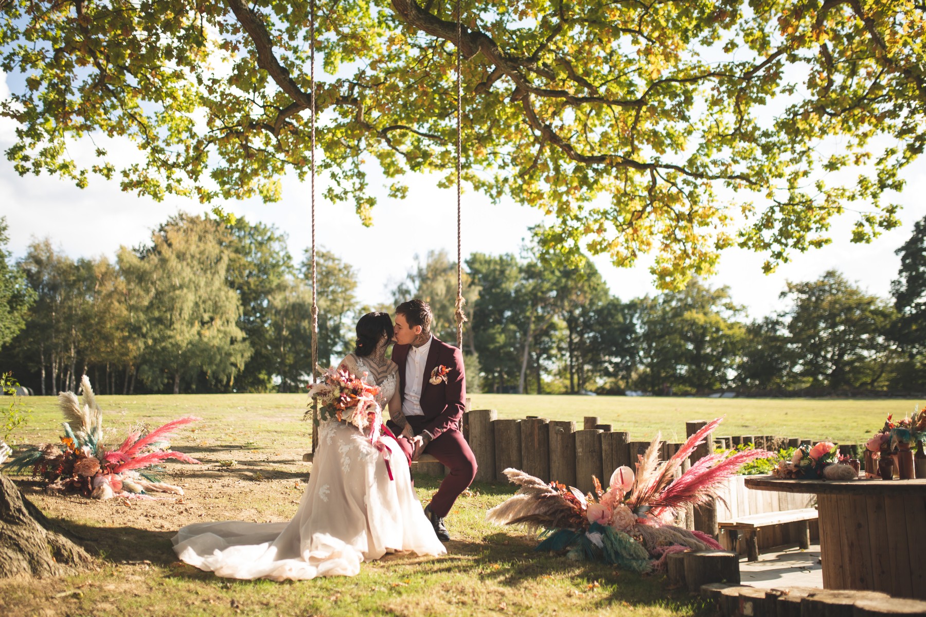 kent outdoor wedding venue - modern outdoor wedding venue - bride and groom in rope swing - alternative wedding - unconventional wedding