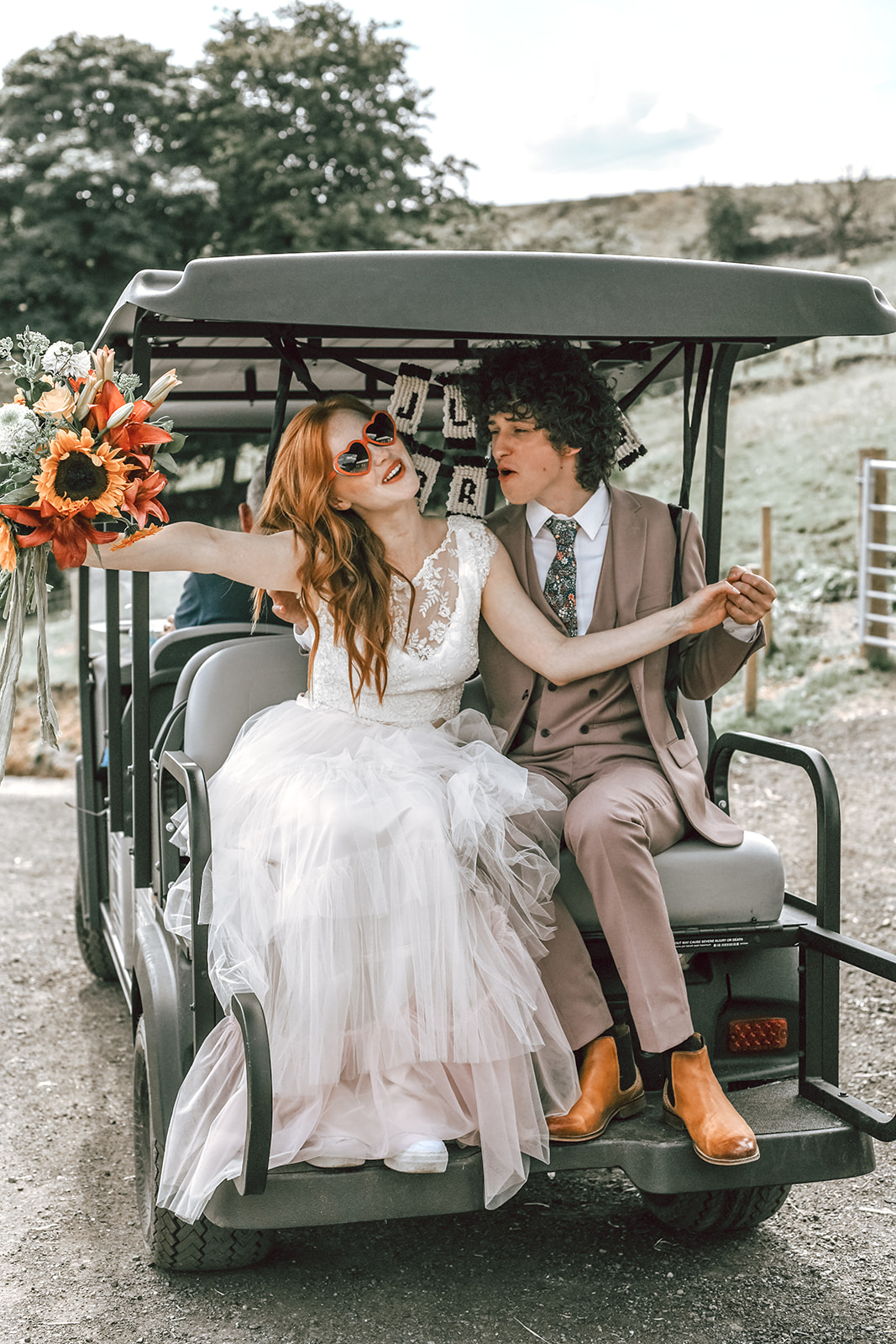 rustic festival wedding - bride and groom in golf buggy - fun boho wedding