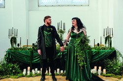 Alternative couple get married. bride wears dark emerald green wedding dress