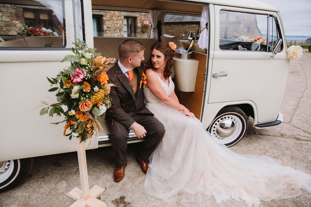 bride and groom in campervan - bohemian wedding transport - unique wedding transport