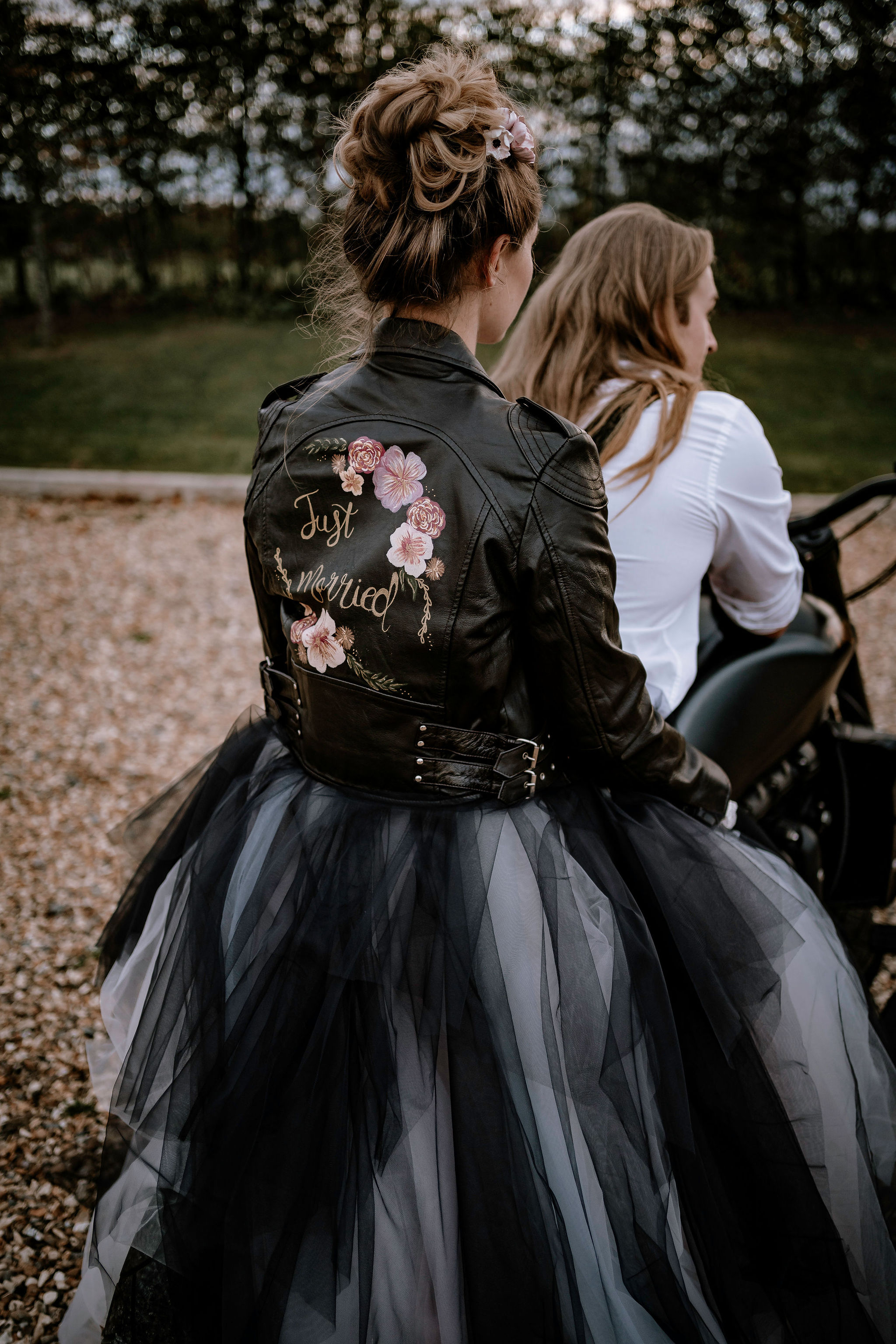 bride on back of motorbike - black wedding dress - hand painted bridal jacket - alternative wedding wear