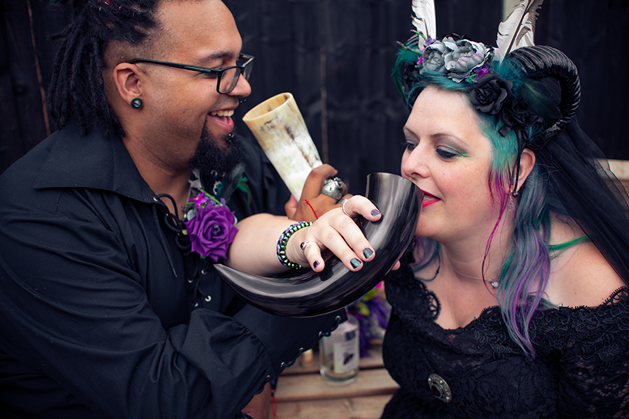 gothic wedding ideas - bride and groom drinking from horns - gothic wedding ideas
