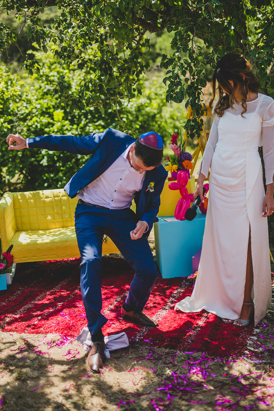 colourful outdoor wedding - groom breaking the glass - colourful wedding ceremony