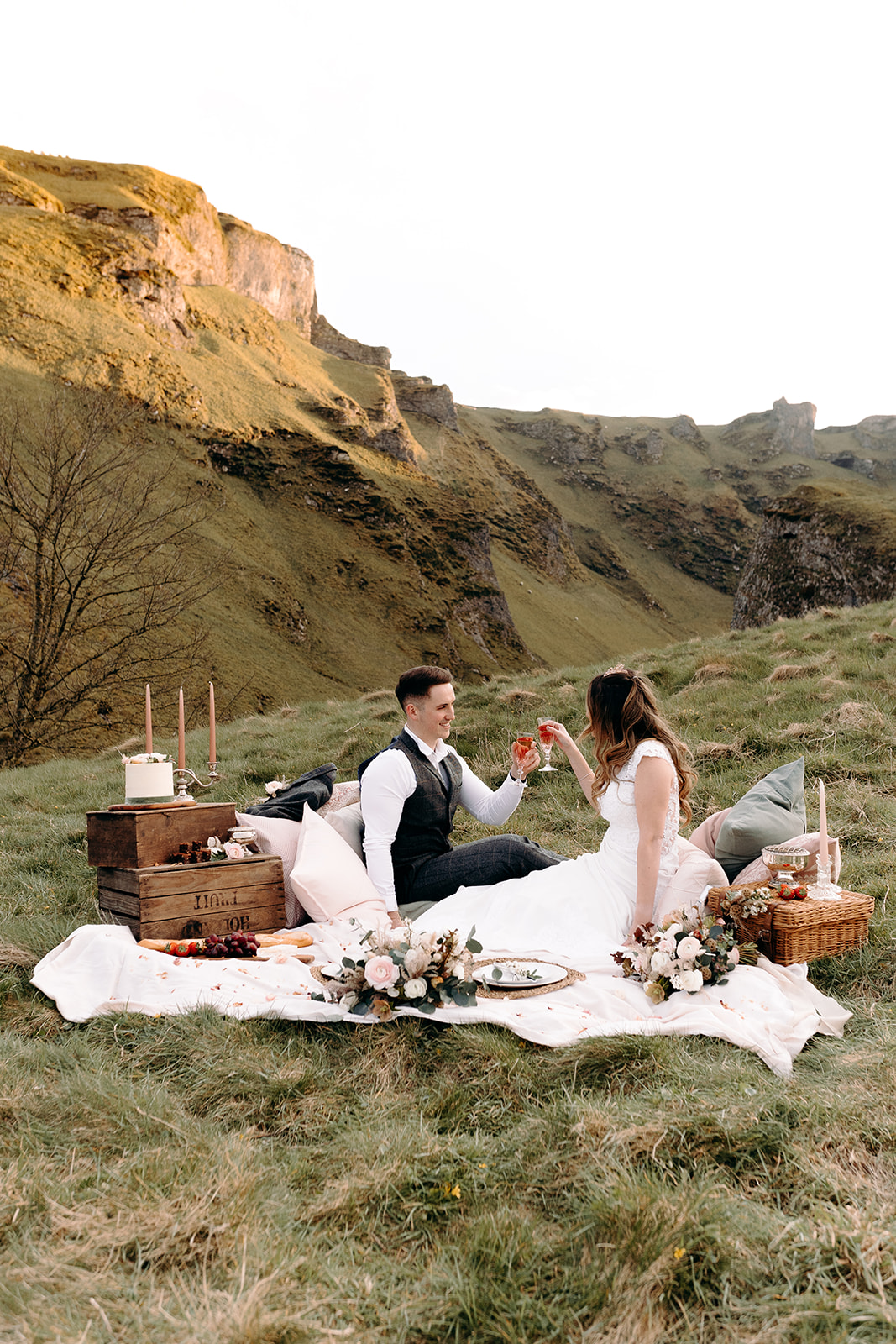 bride and groom having a picnic in the countryside - elopement picnic styling - bohemian elopement