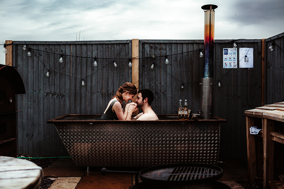 bride and groom in outdoor hot tub - unique wedding venue
