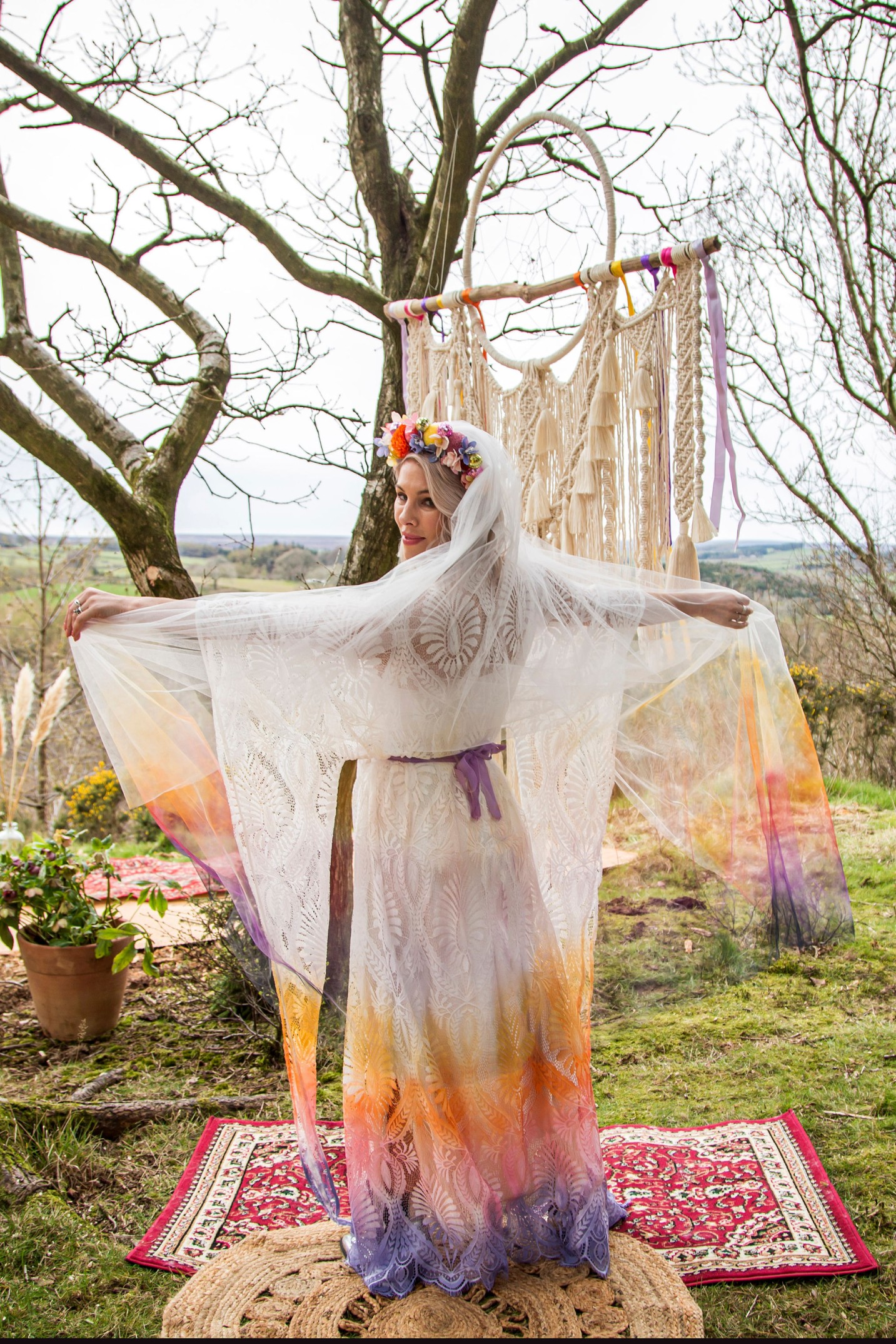 Alternative Bride wearing ombre colourful wedding dress by bexbrides with purple belt - standing outdoors with arms out wide - Daze photography 1