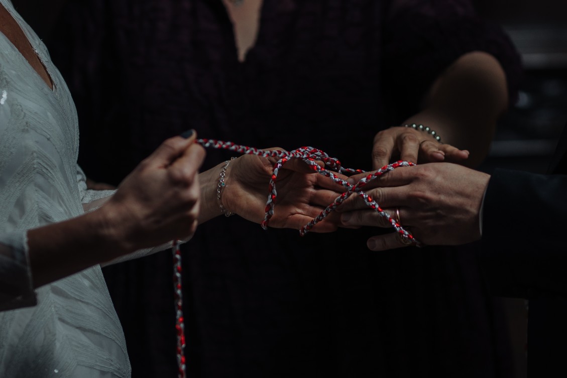 handfasting ceremony with red and white thread