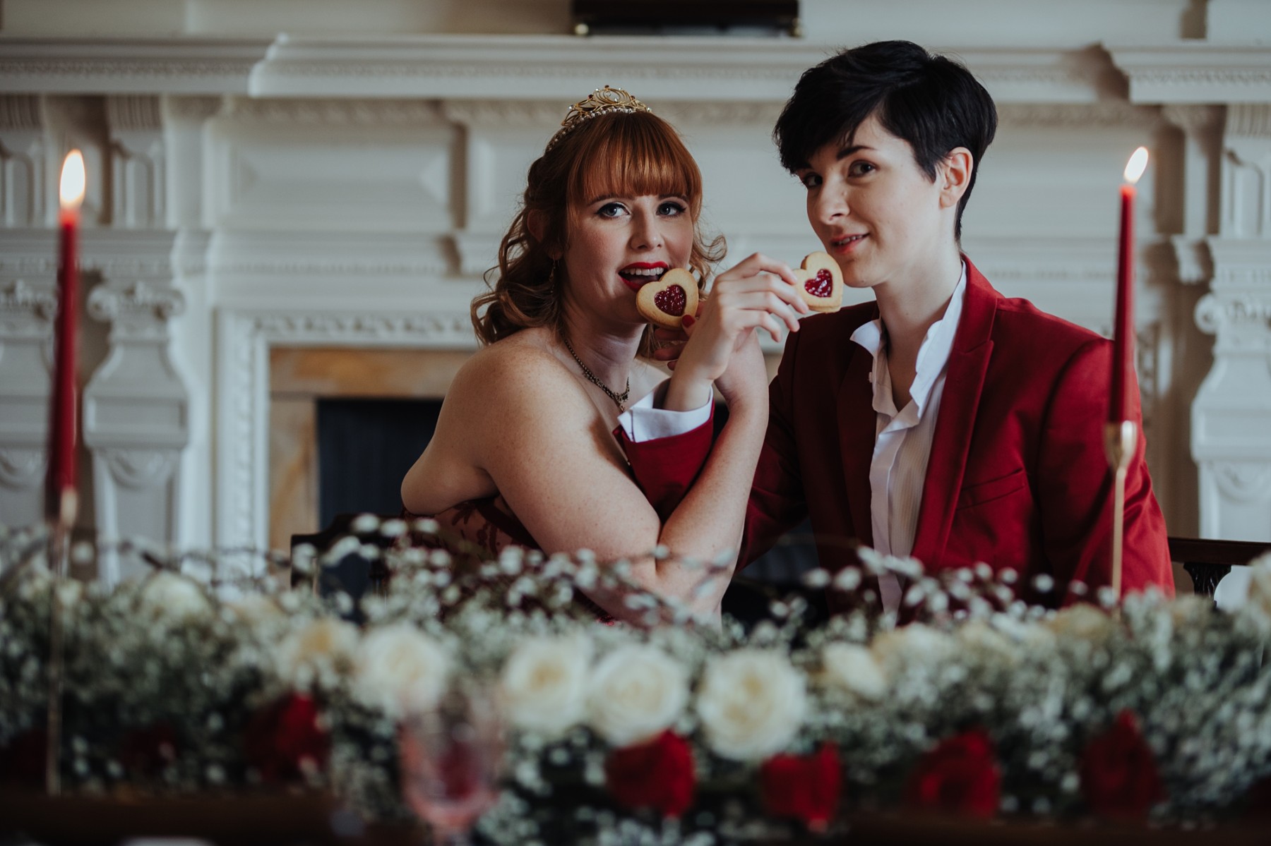 newlyweds eating cookies - red wedding inspiration - unique wedding ideas