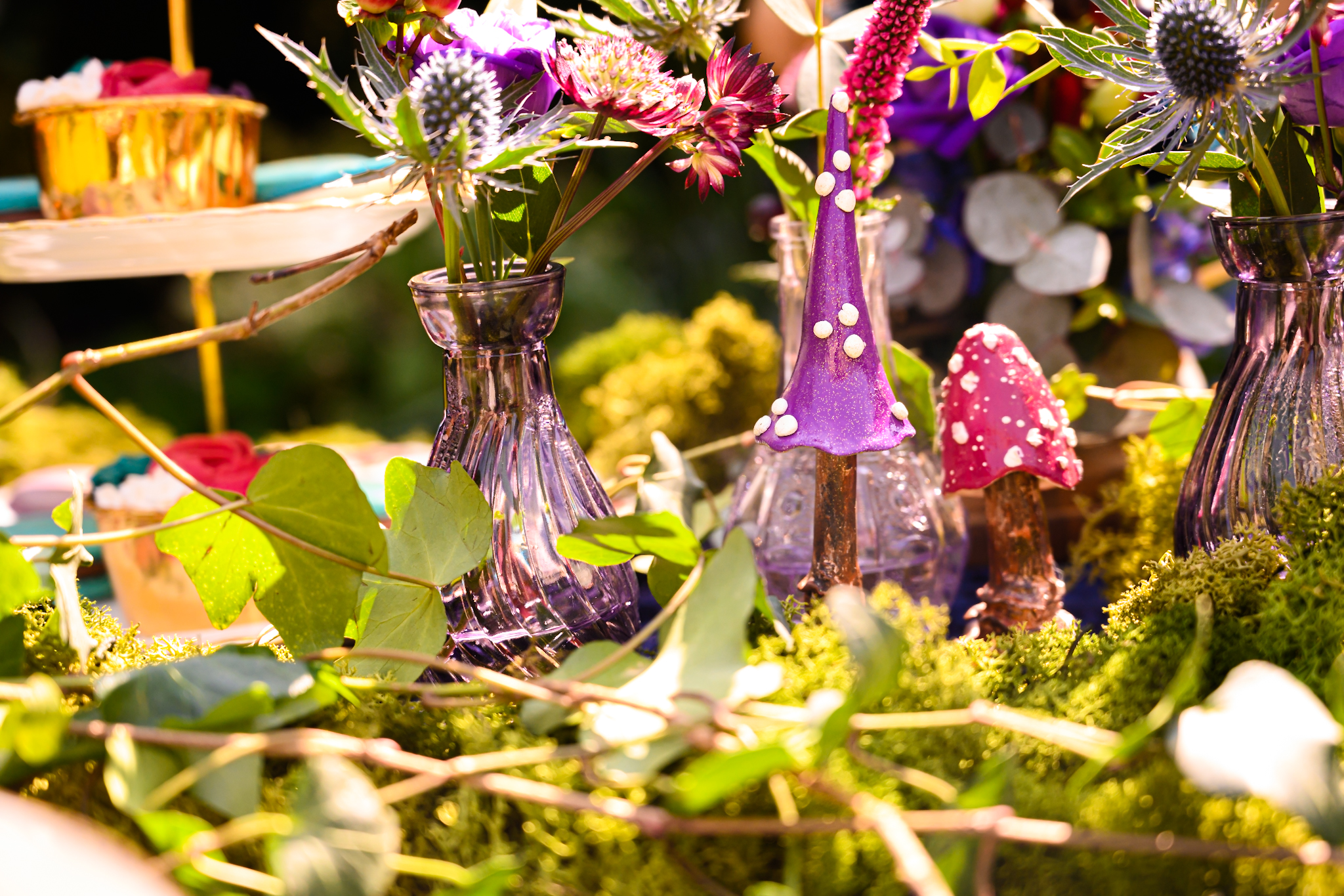 wedding table decorated with moss, flowers and mushroom sculptures, magical wedding ideas