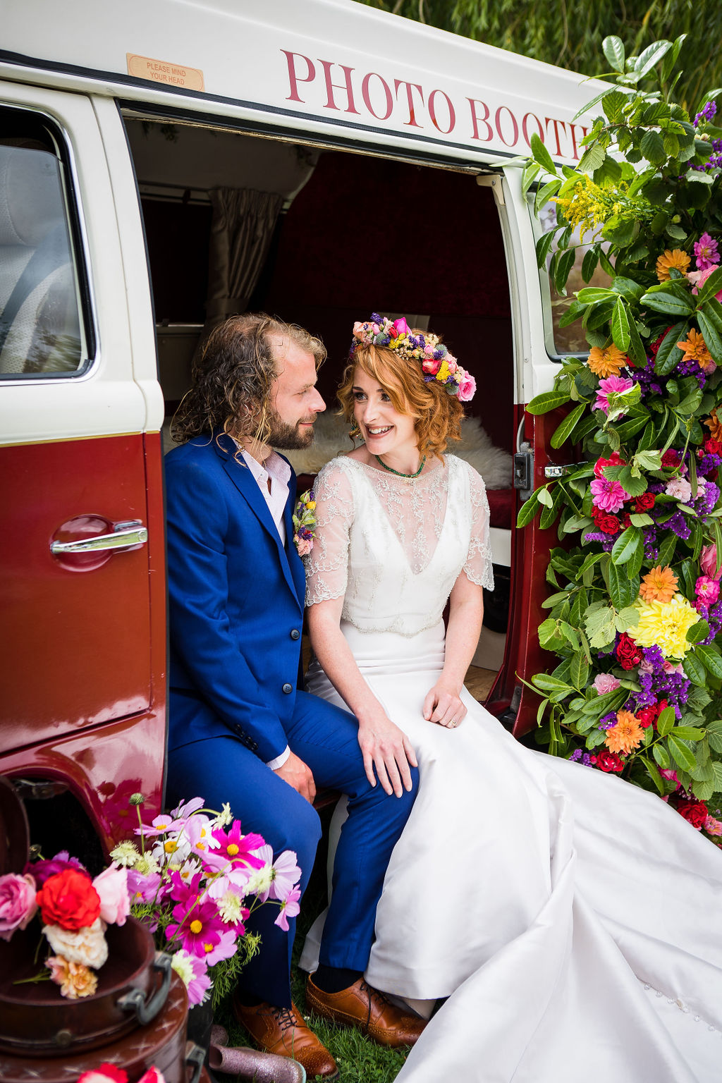 bride and groom sitting in campervan photobooth