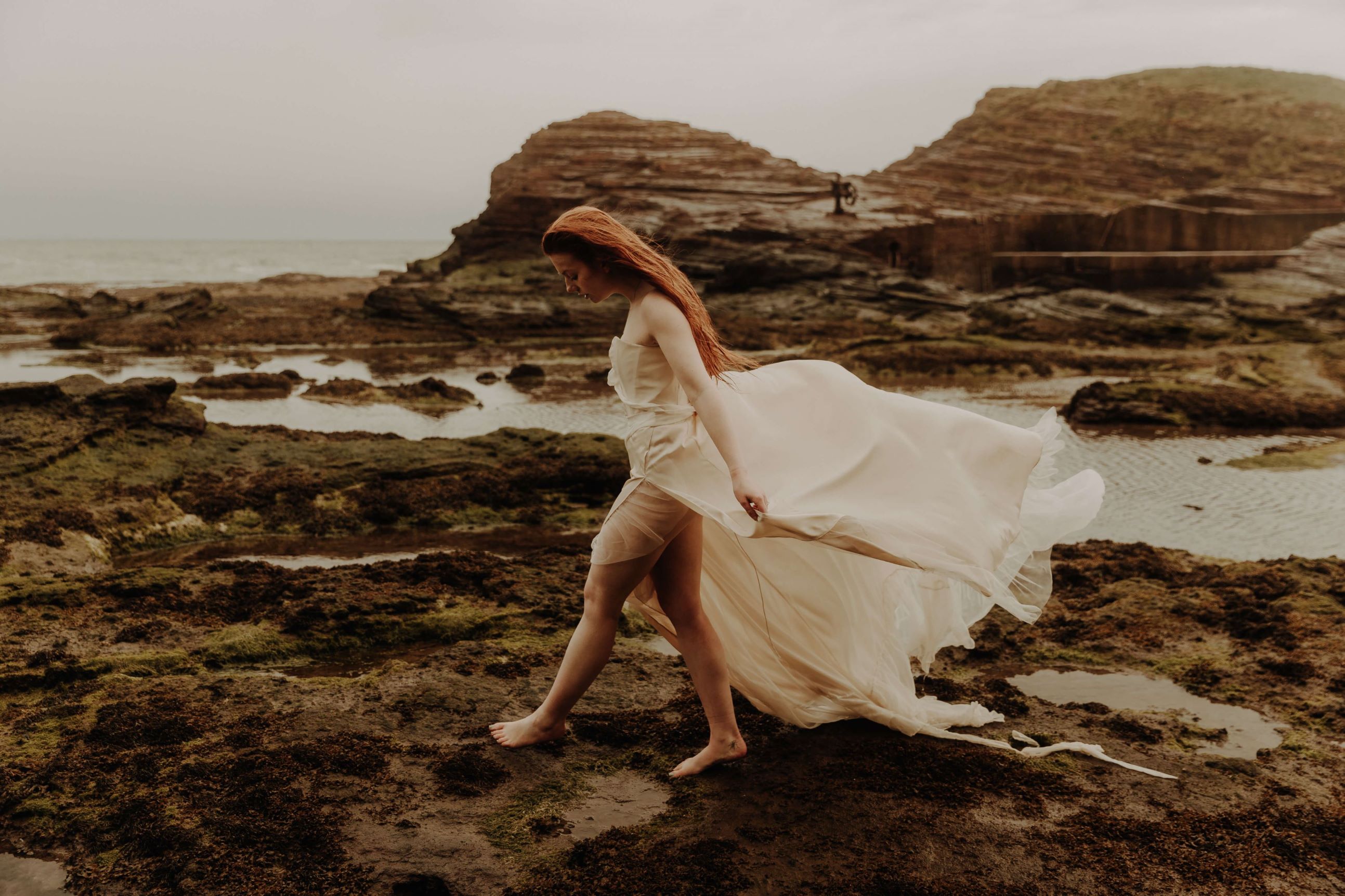 Boho bride with auburn hair on the beach - Cora Stitches Bridal Design