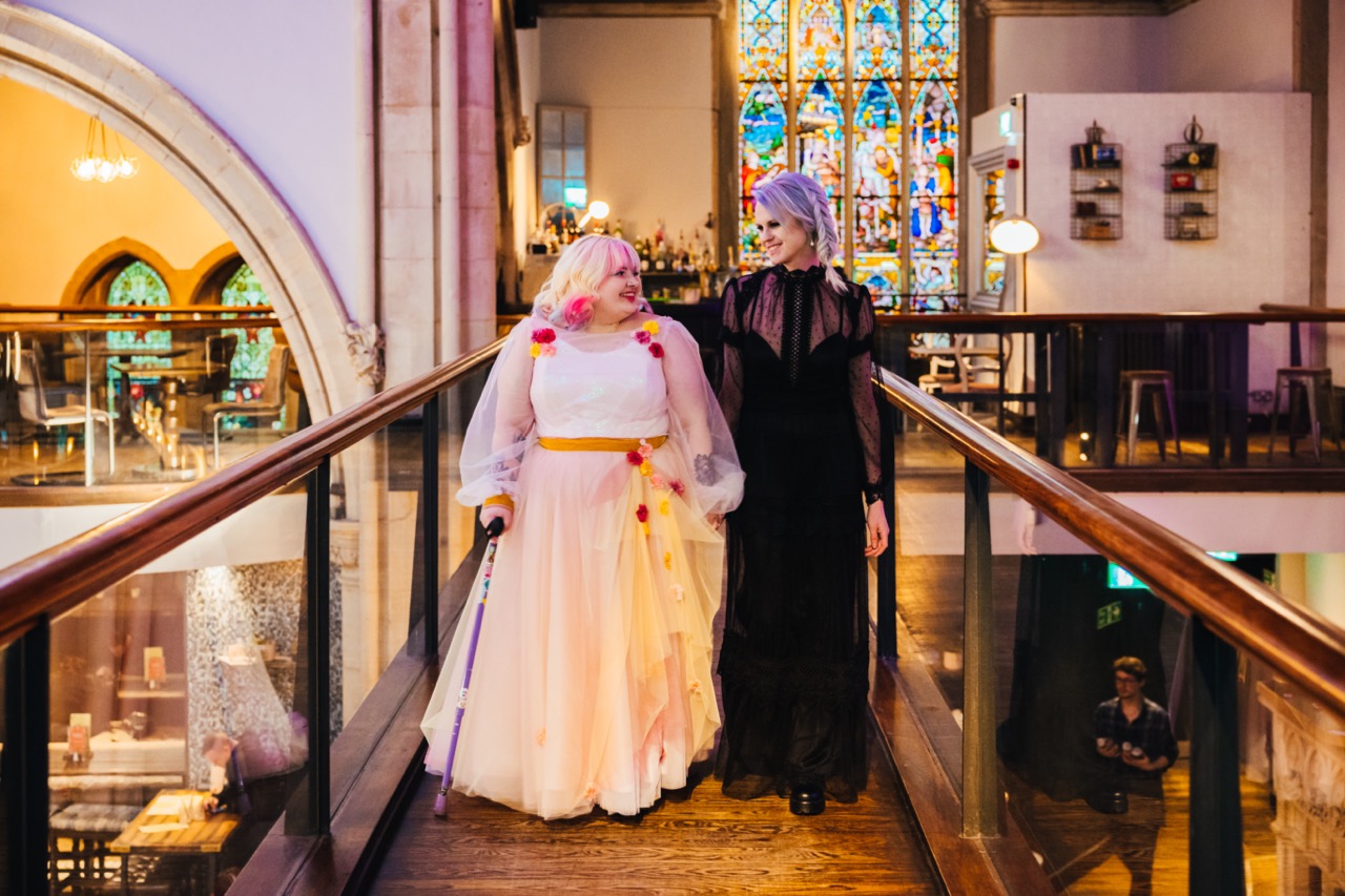 A bride in a white dress and a bride in a black dress - Accessible wedding planning