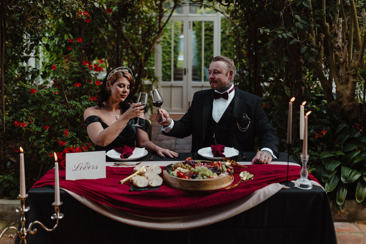 couple toasting each other at their intimate alternative wedding