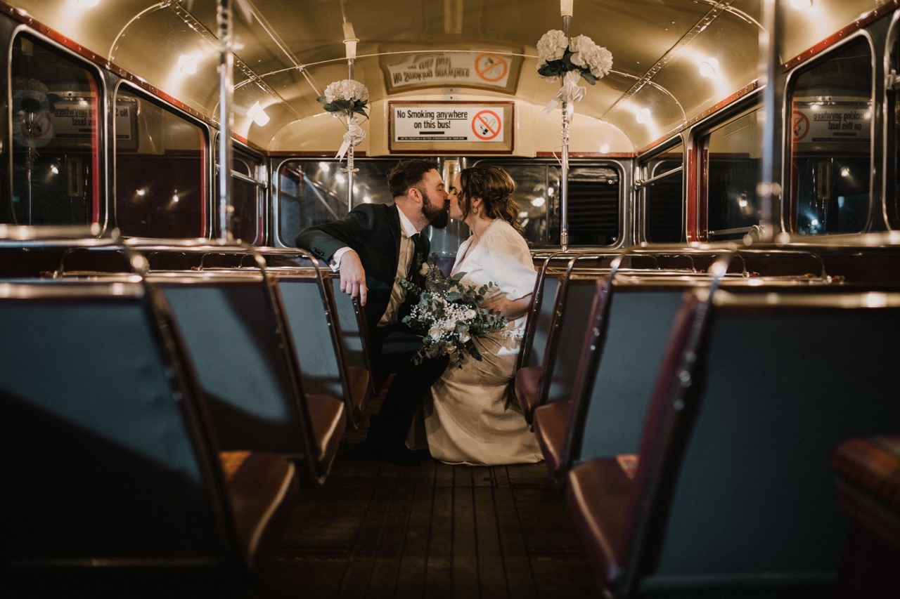 bride and groom on top deck of red london bus - unique wedding transport ideas
