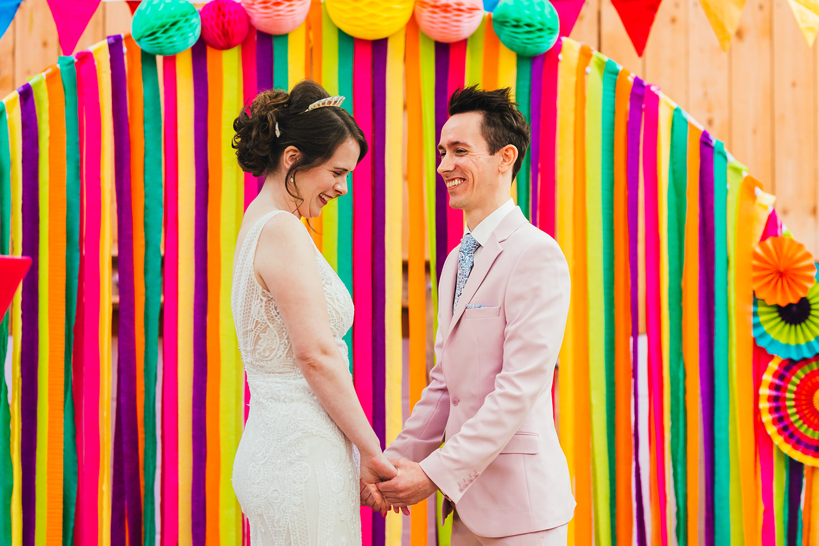 rainbow wedding backdrop made from ribbons and paper lanterns - unique wedding backdrop