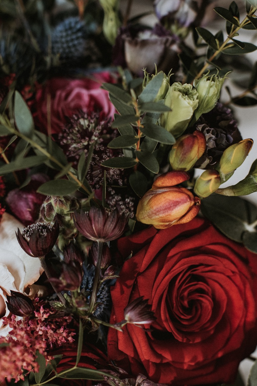 gothic wedding flowers with deep red roses and dark green foliage