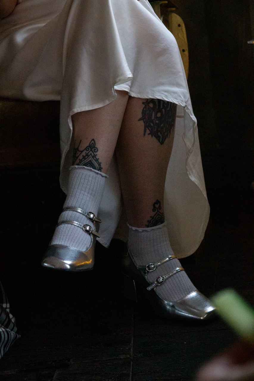 bride wearing silver shoes with white socks - unique wedding shoes inspiration