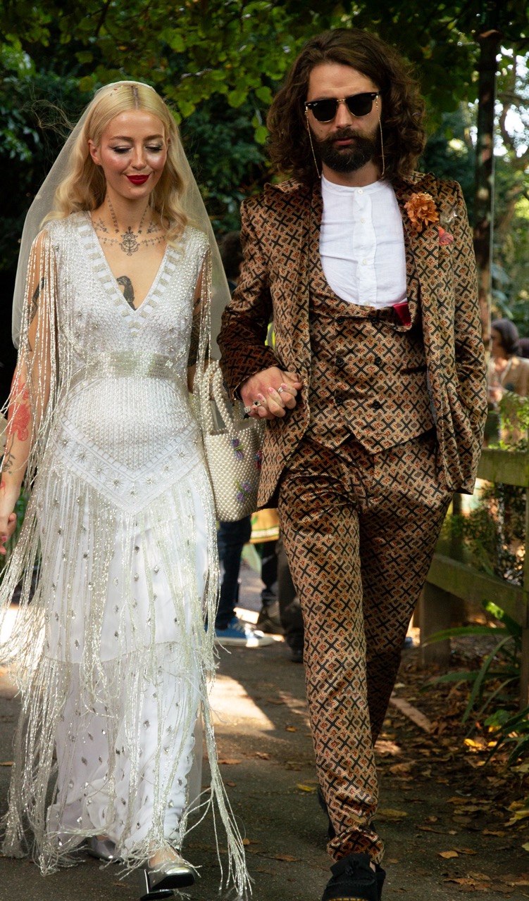 stylish bride and groom walking through brighton - unique wedding wear for city wedding