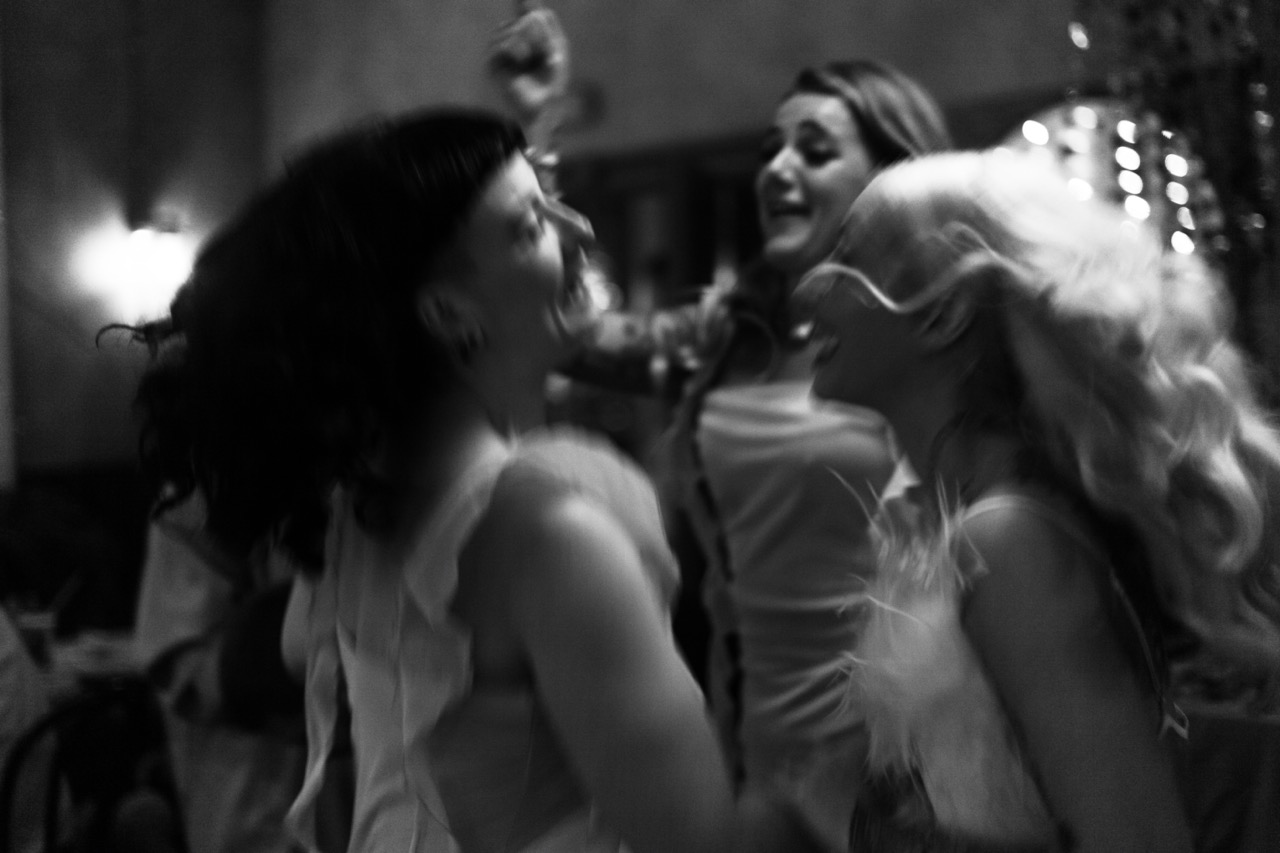 black and white wedding photo of bride dancing with her bridesmaids