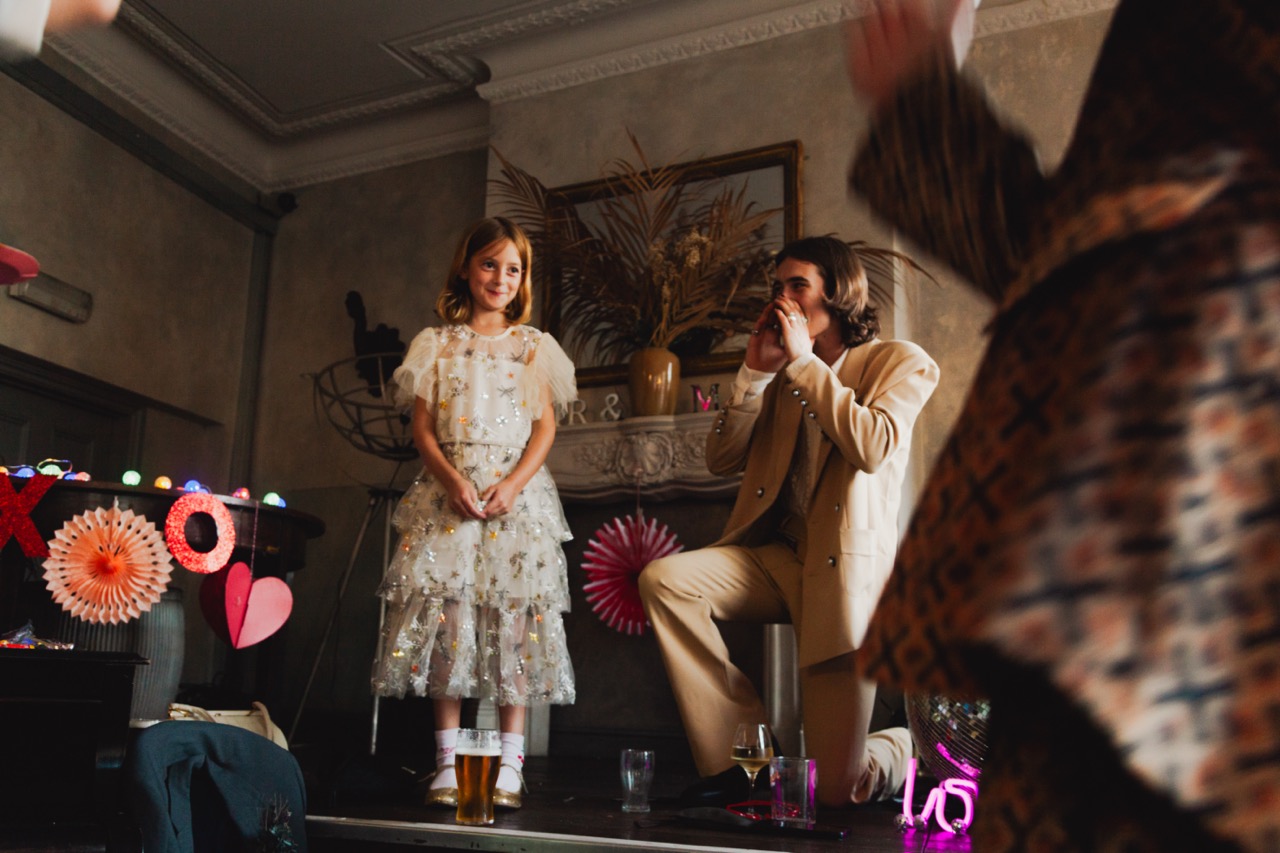daughter of bride and groom making a speech at her parents wedding
