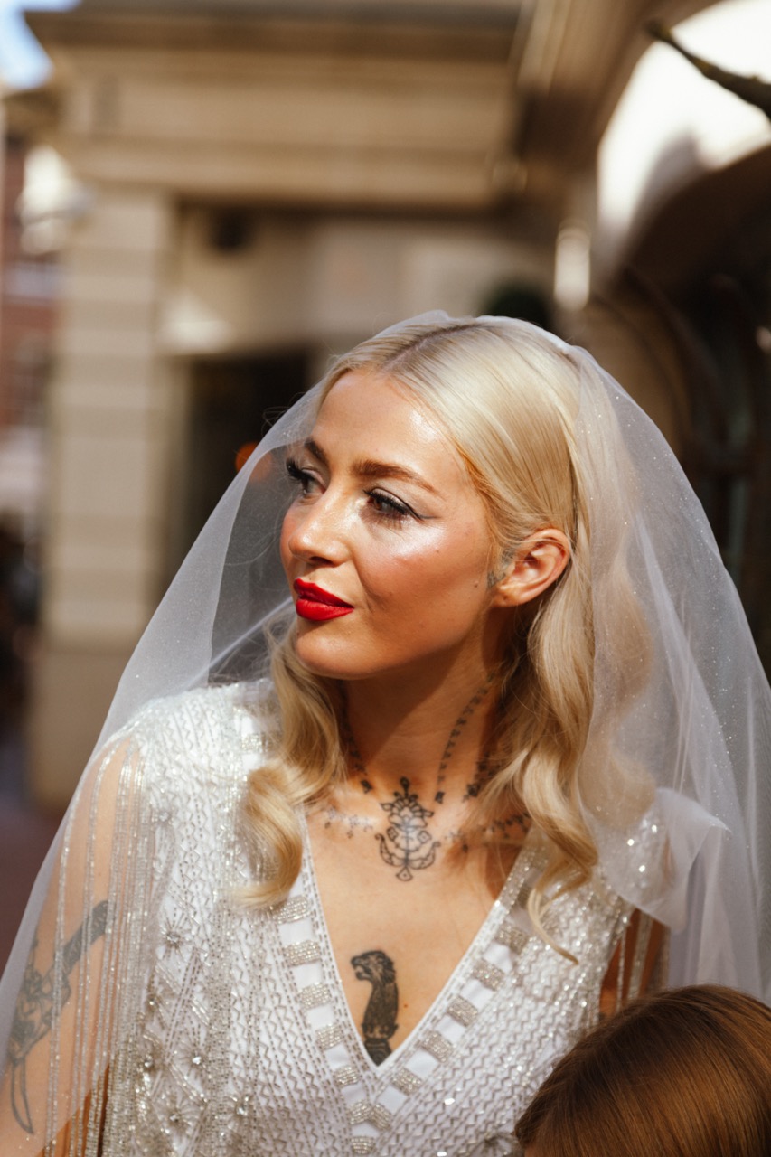 tattooed bride with red lipstick and beaded wedding dress