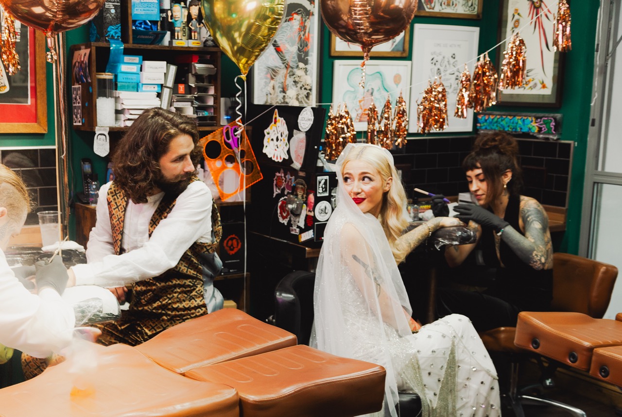 bride and groom getting wedding tattoos at brighton tattoo shop
