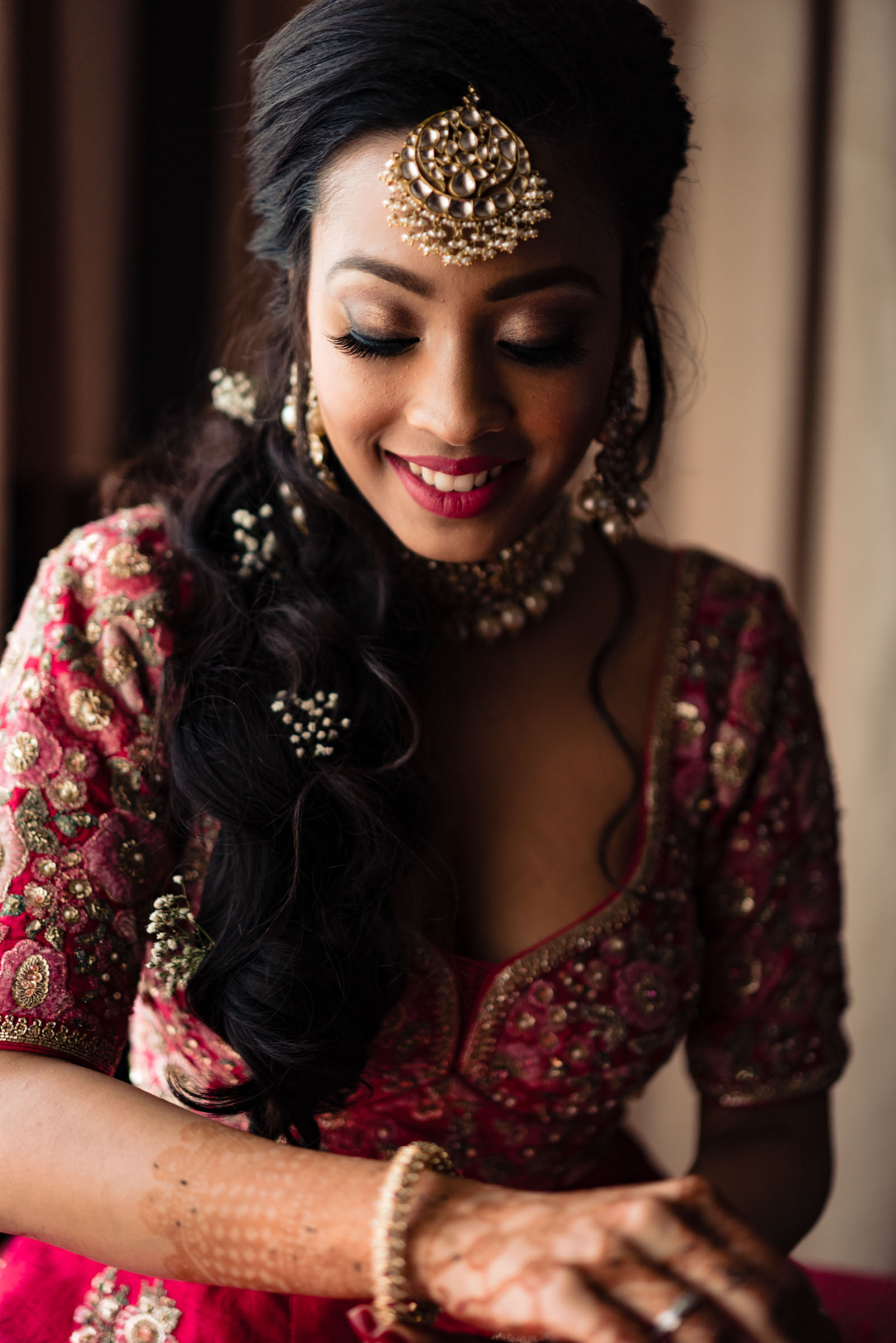 bride in traditional indian wedding attire, getting ready for her destination wedding