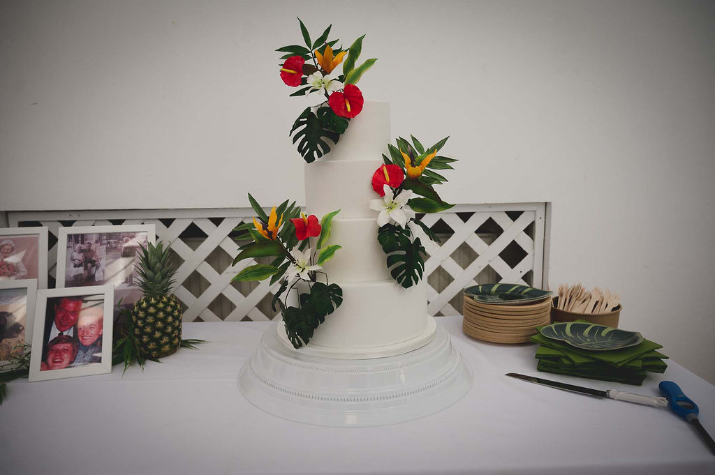 tropical wedding cake with monstera leaves and birds of paradise