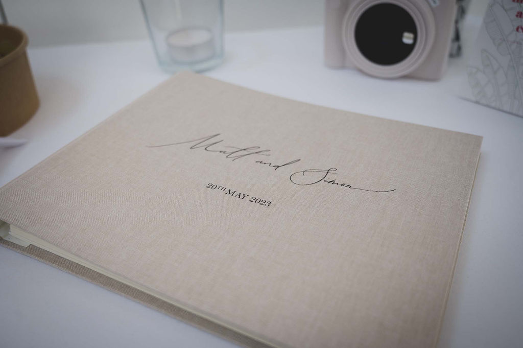 personalised wedding guest book with calligraphy on the front