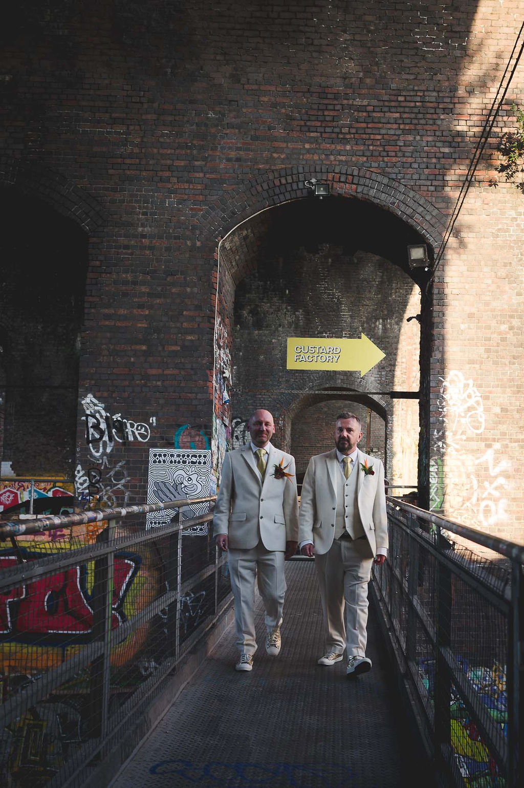 urban wedding photos in birmingham of two grooms in ivory suits