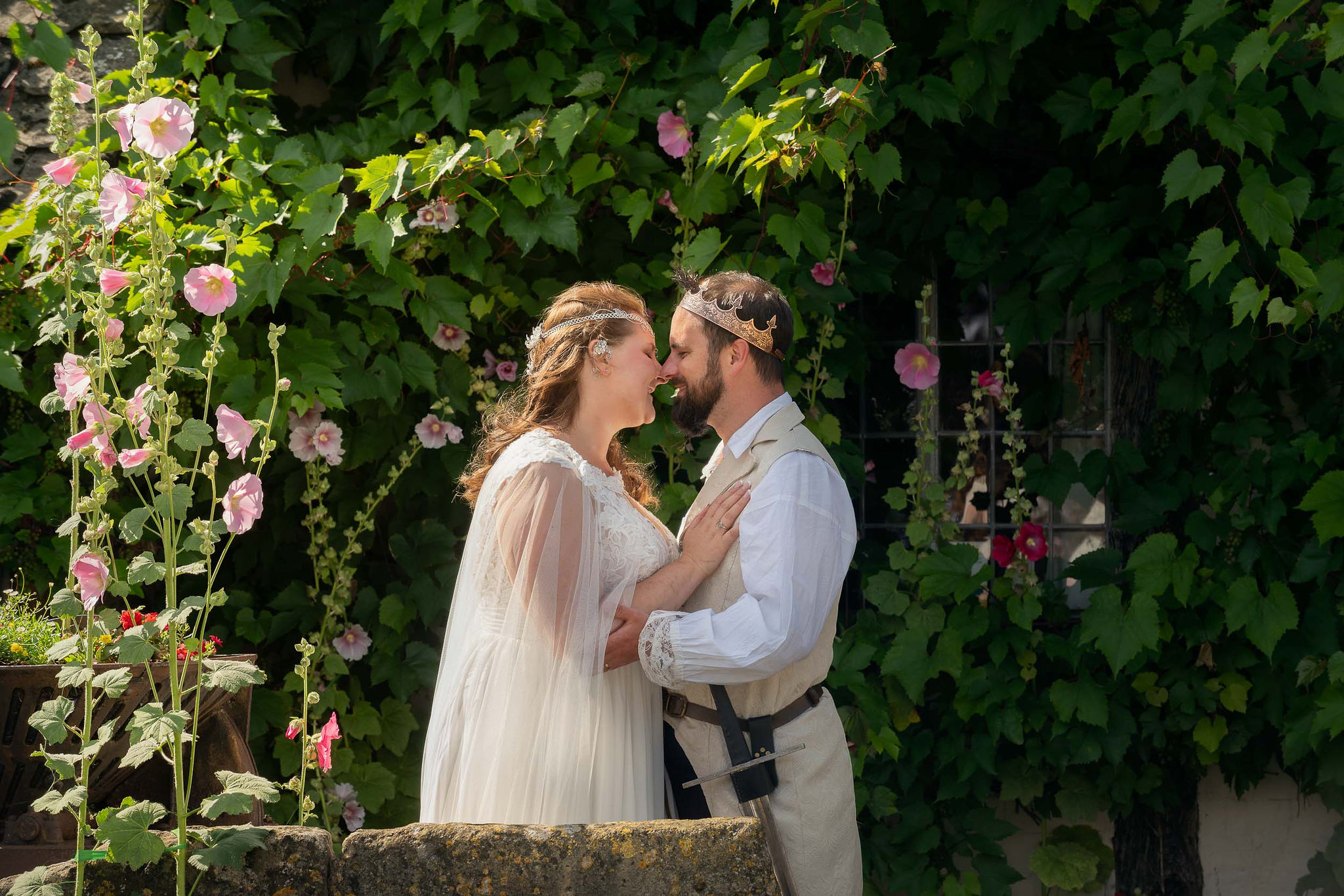 bride and groom in flower garden at their medieval wedding