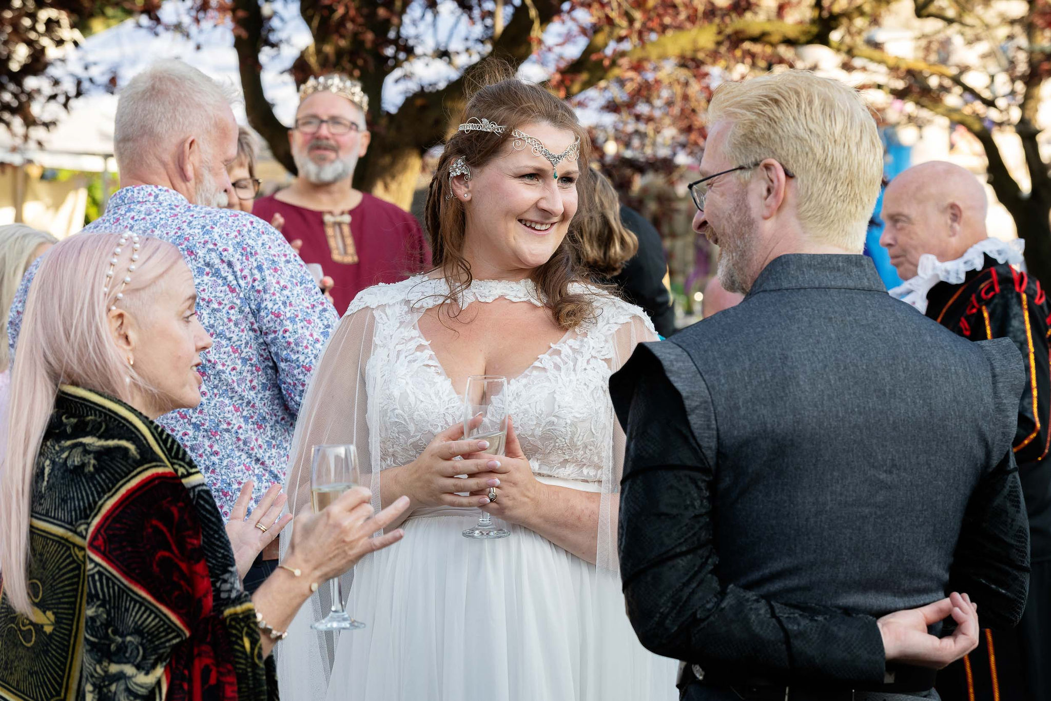 bride wearing an elven headdress speaking to guests at fantasy wedding