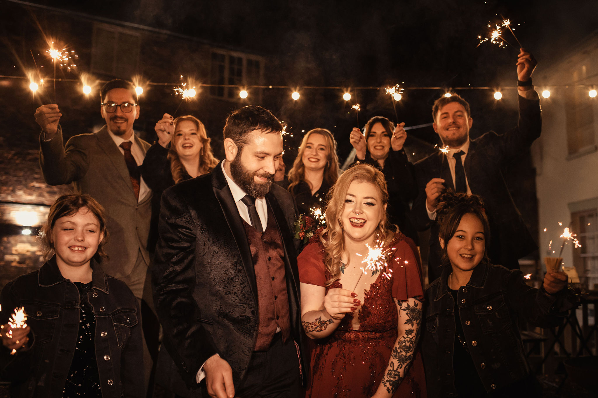 night time wedding group photo with sparklers