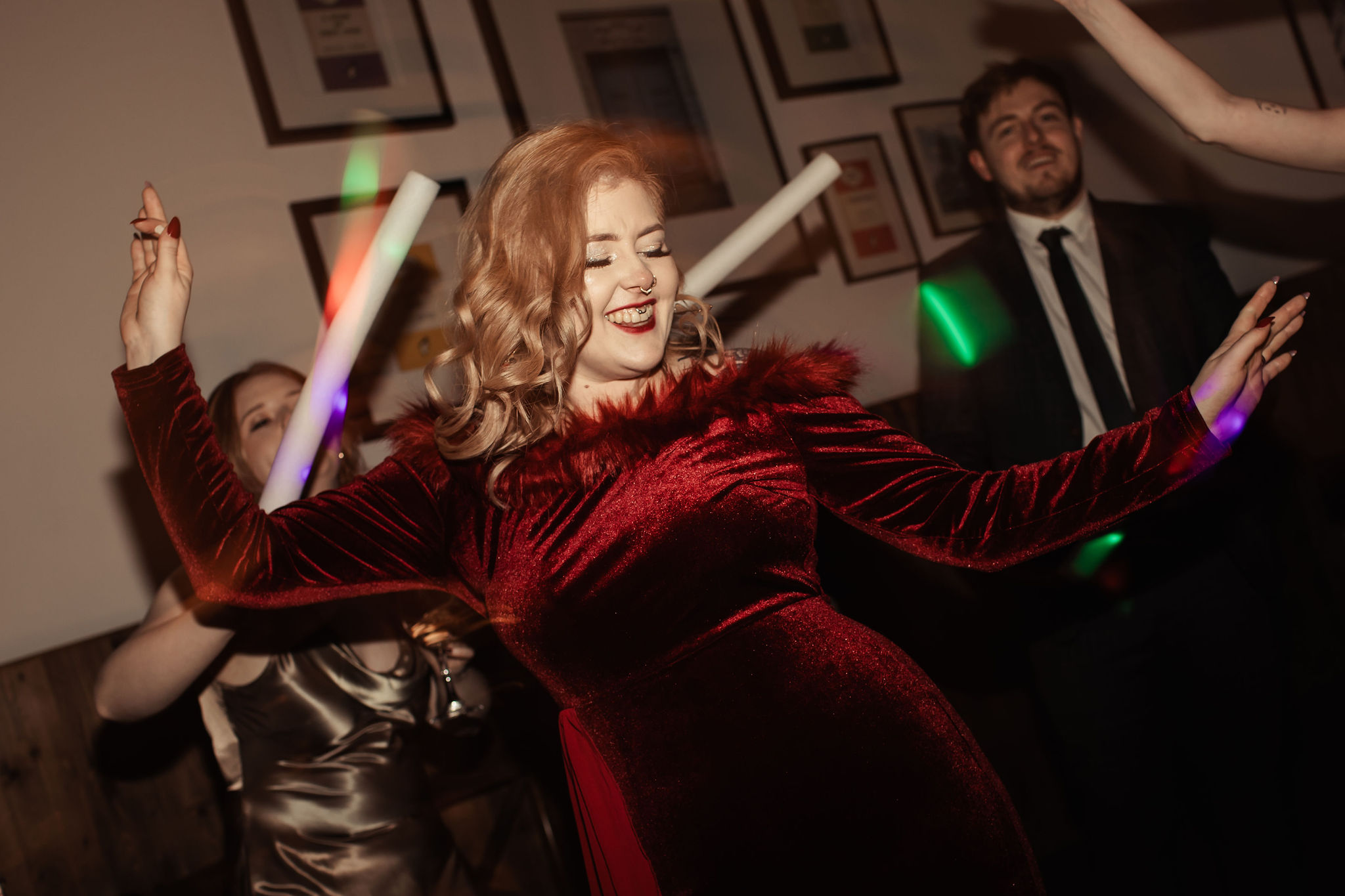 bride dancing at her pop punk wedding, wearing a red wedding dress
