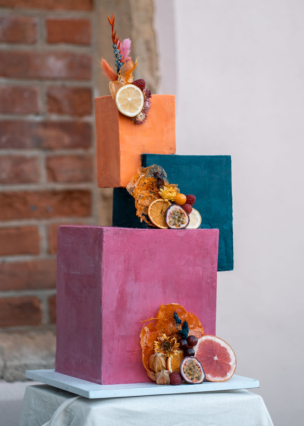 unique wedding cake with cube tiers, decorated with dried fruit